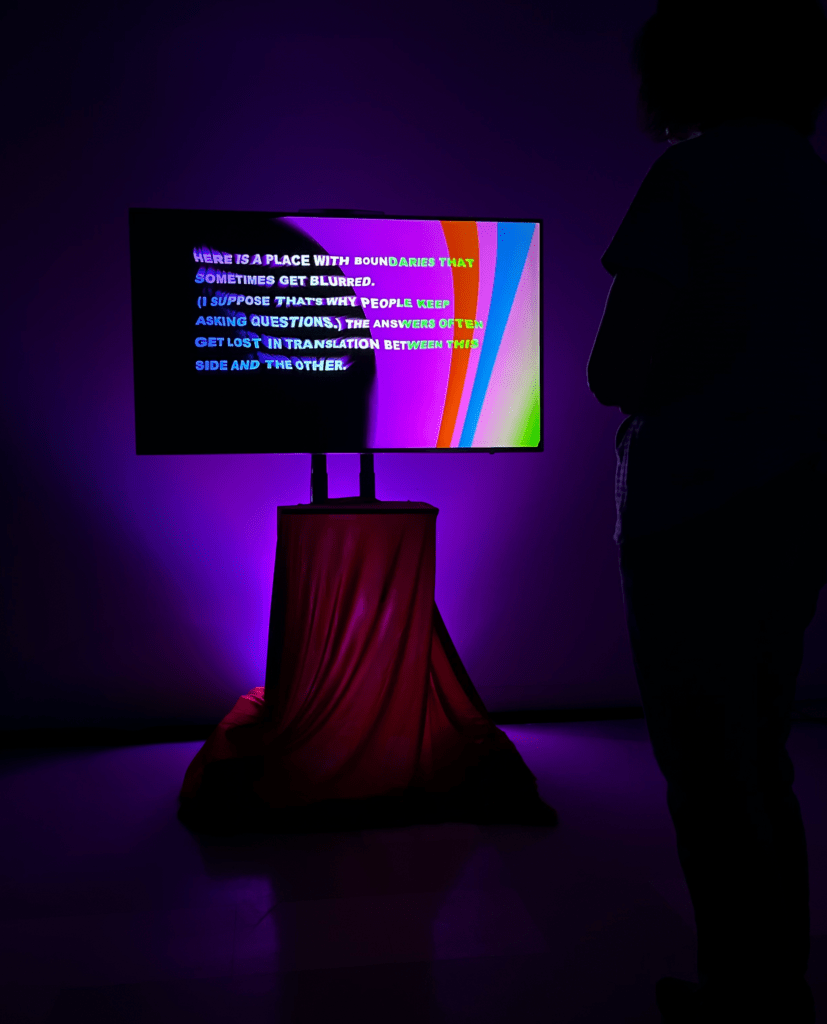 Visitor at Deep World monitor on pedestal. Pedestal with red velour drape and purple uplight. 